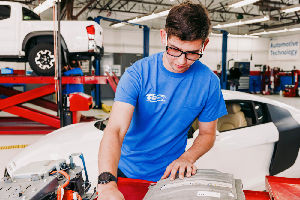 Student in automotive lab working on car