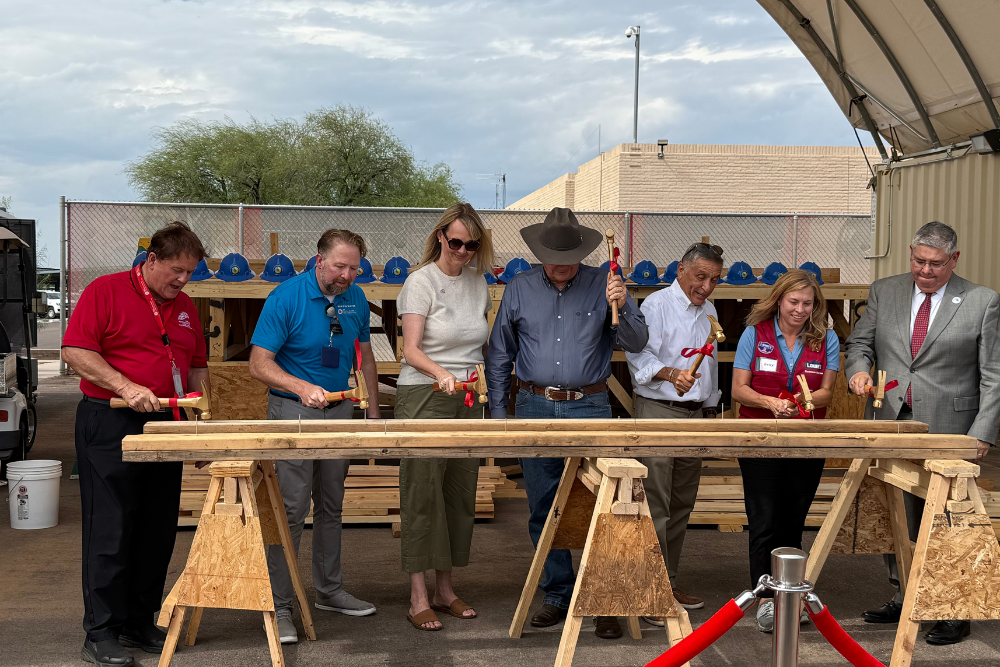 Men and women at a construction site grand opening