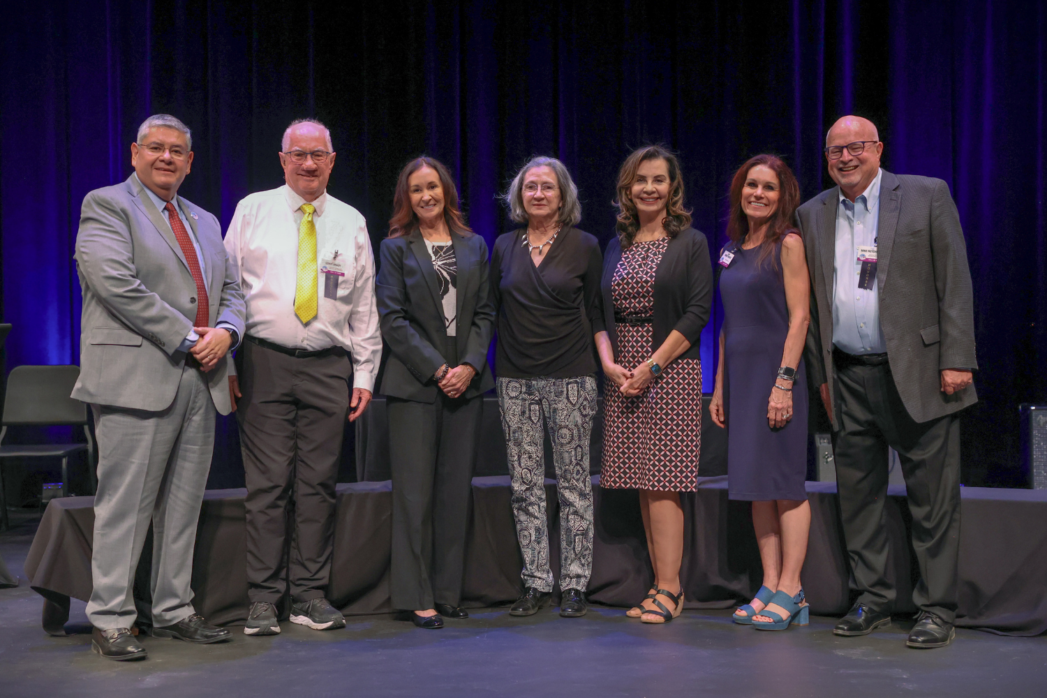 Men and women on stage at awards ceremony