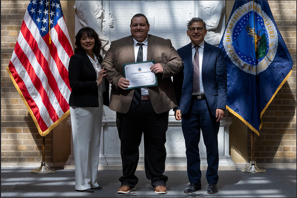 MCC journalism faculty holding award