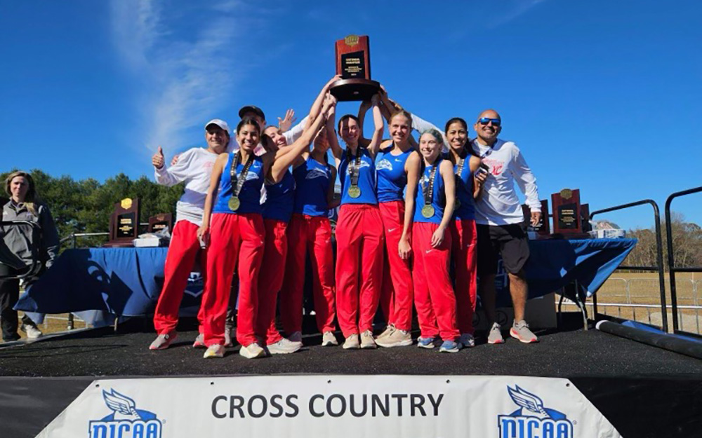 MCC Women's Cross Country team holding trophy