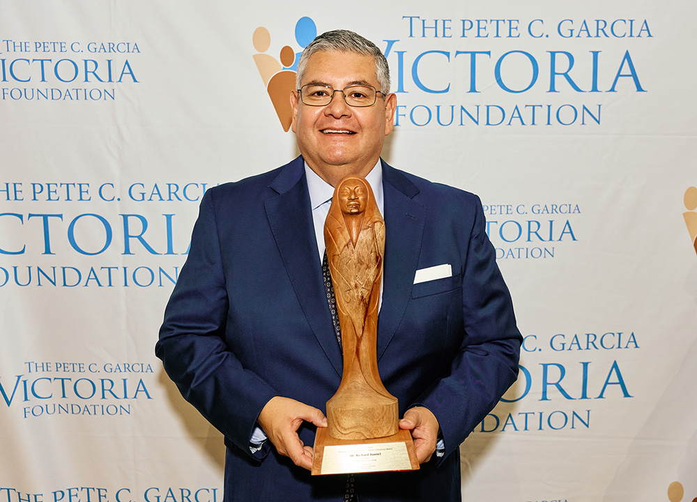 Dr. Richard Daniel holding award